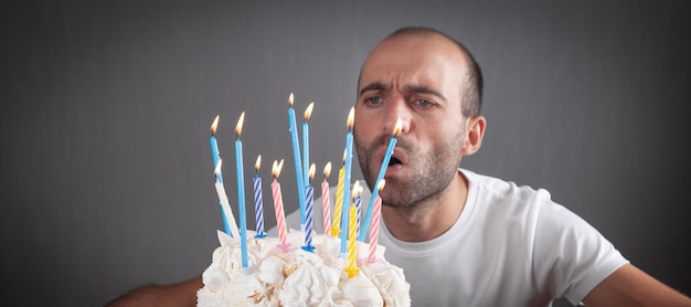 Caucasian man blowing birthday candles