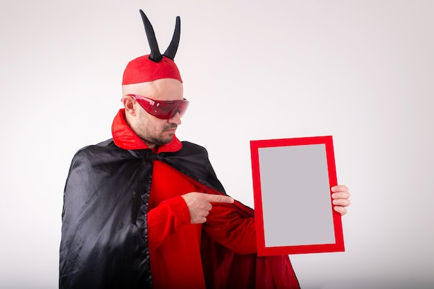 Caucasian man in halloween costume demonstrating empty nameplate