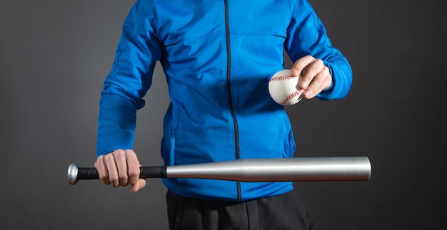 Caucasian man holding baseball bat and ball