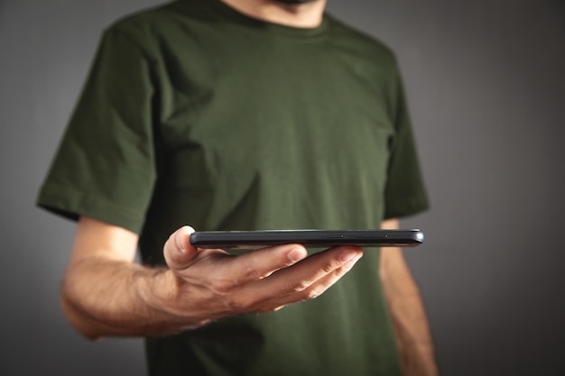 Caucasian man holding smartphone at home