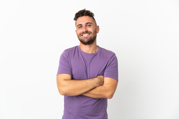 Caucasian man isolated on white wall with arms crossed and looking forward