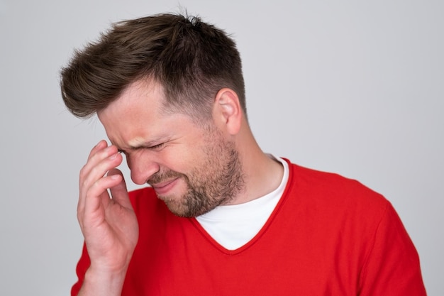 Caucasian man showing how much his head hurts experiencing pain