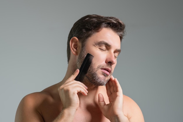 Caucasian man trying to make a beard hair comb by himself with comb male haircut male haircut carber