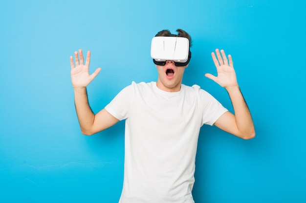 caucasian man using a virtual reality glasses