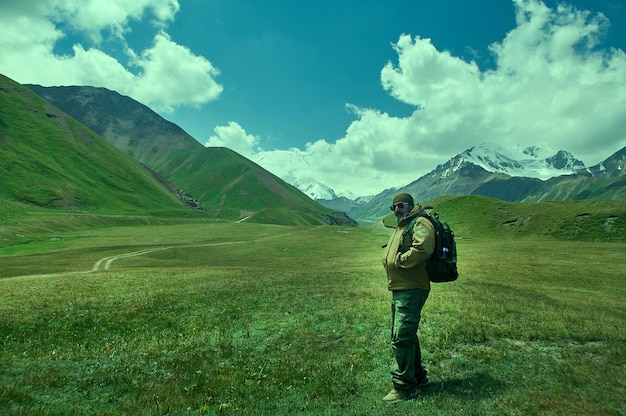 Caucasian man with backpacks View from p Pamir