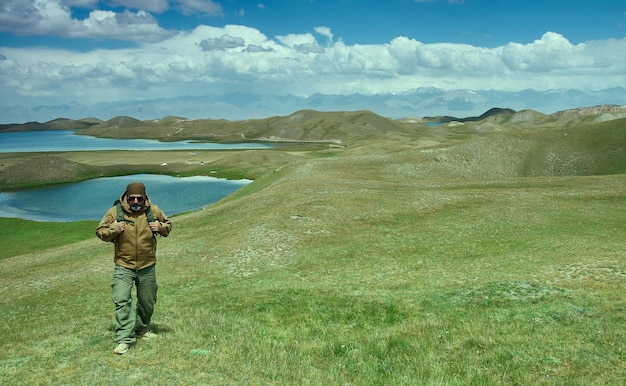 Caucasian man with backpacks View from p Pamir