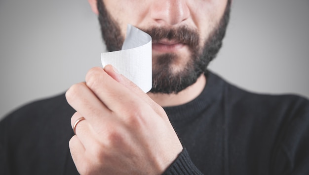 Caucasian man with tape on mouth. Censorship concept