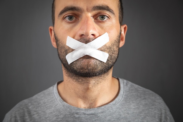 Caucasian man with tape on mouth Censorship