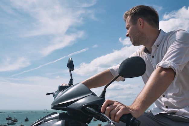 Caucasian man without helmet sit on motorbike