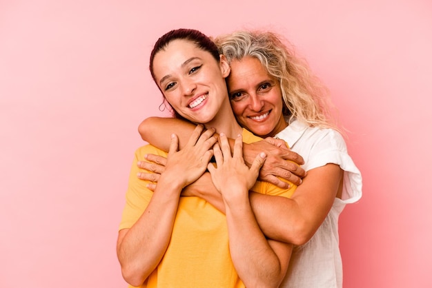 Caucasian mom and daughter isolated on pink background