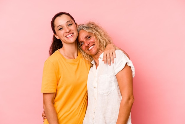 Caucasian mom and daughter isolated on pink background