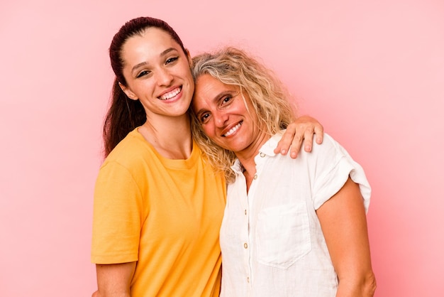 Caucasian mom and daughter isolated on pink background