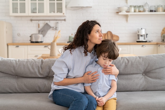 Caucasian mother feel sorry after fight and scold of preschool son hug him in comfort love and care