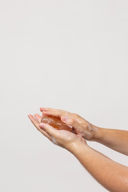 Caucasian person washing hands with soap