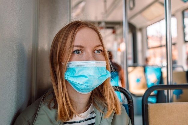 Caucasian s woman in face mask public transport passenger traveling in tram high quality photo