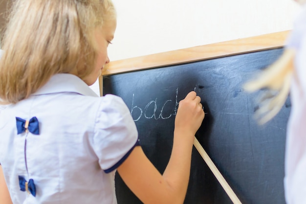 Caucasian school girl have fun at small desk