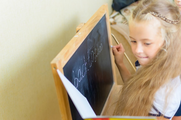 Caucasian school girl have fun at small desk