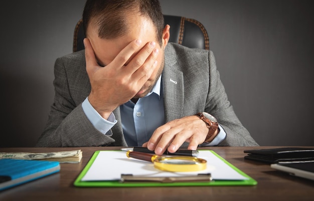 Caucasian stressed businessman sitting in office