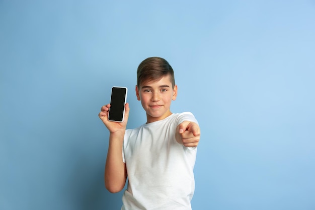 Caucasian teens portrait isolated on blue studio background