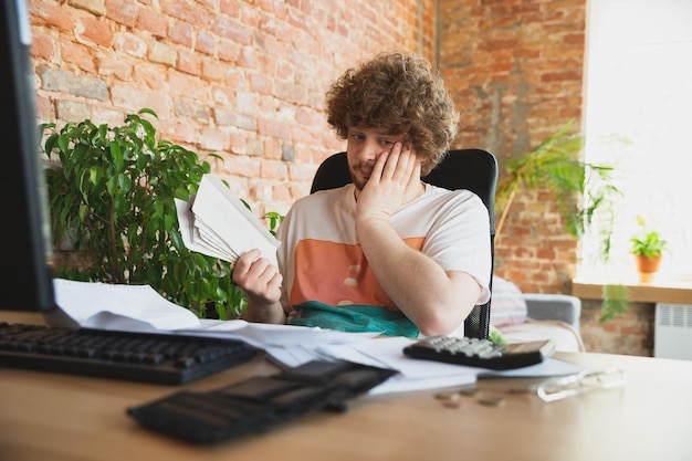 Caucasian upset and despair man doing financial and economical reports