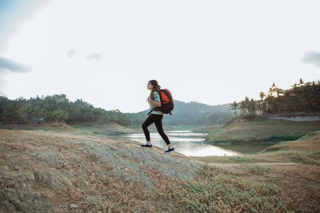 Caucasian woman alone walking lake side