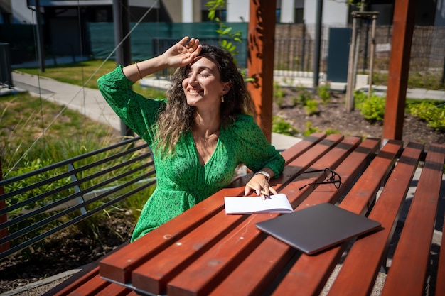 Caucasian woman drawing ideas on a notebook outside office