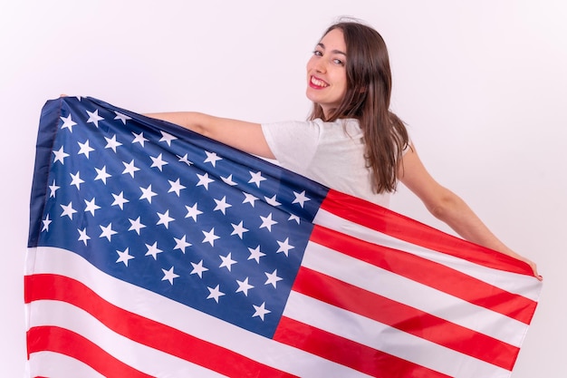 Caucasian woman from behind smiling with usa flag isolated on a white background