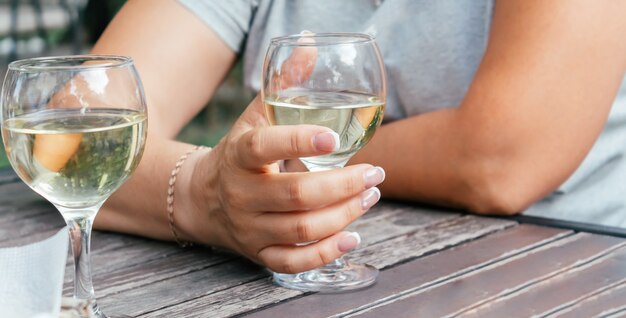 Caucasian woman holding glass of white wine