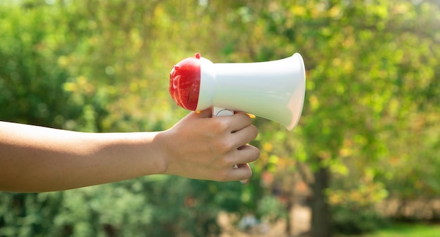 Caucasian woman holding megaphone at outdoor