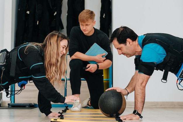 Caucasian woman and a middle-aged man exercising together