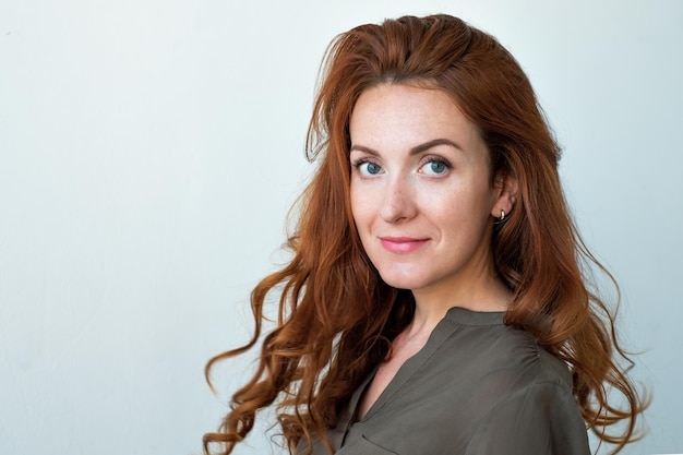 Caucasian woman model with ginger hair posing indoors