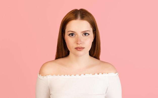 Caucasian woman's portrait isolated over pink studio background with copyspace for ad Concept of beauty health