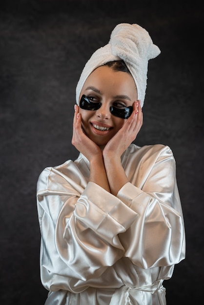 Caucasian woman use black patches after shower isolated on black