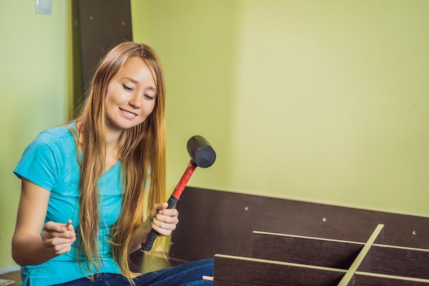 Caucasian woman using screwdriver for assembling furniture