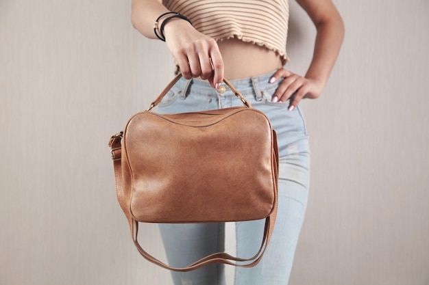 Caucasian woman with a brown bag at home.