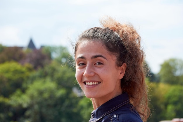 A Caucasian woman with a ponytail smiling