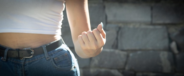 Caucasian young woman threatening with fist