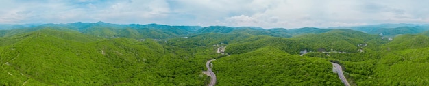 Caucasus mountains and forest panorama rural road