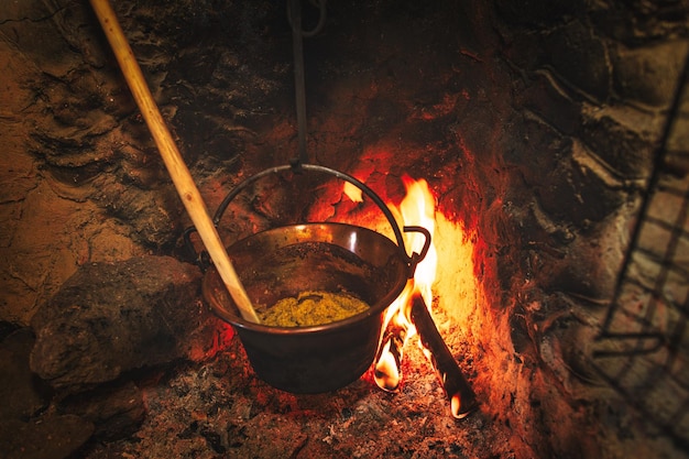 Cauldron with polenta on the fire