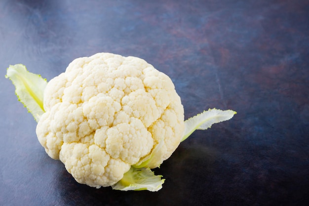 Cauliflower on dark background Organic cauliflower on dark background Vegan healthy food Copy space