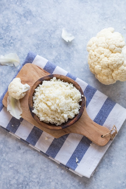 Cauliflower flour and vegetable on a cutting board. Healthy food.