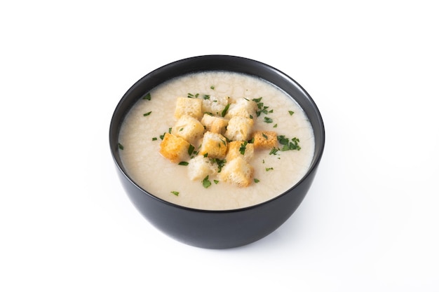 Cauliflower soup in a bowl isolated on white background