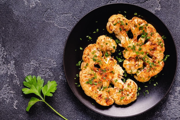 Cauliflower steak with spices cooked in the oven top view