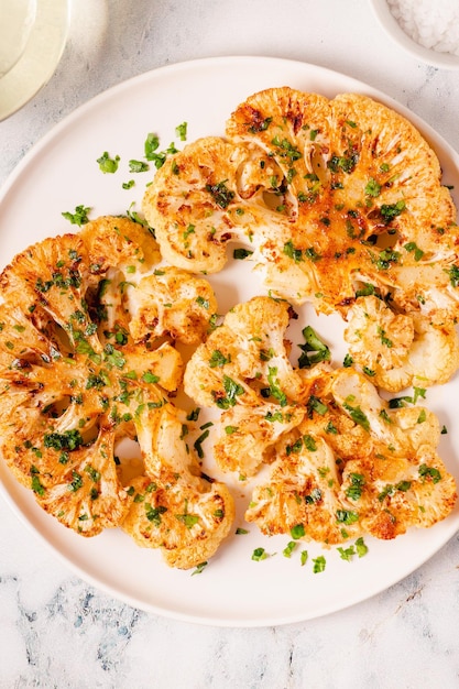 Cauliflower steak with spices cooked in the oven top view