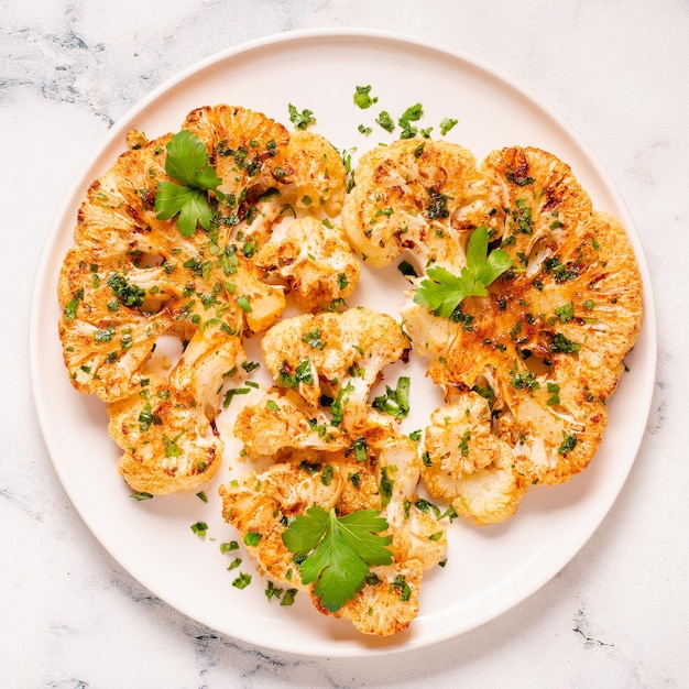 Cauliflower steak with spices cooked in the oven top view