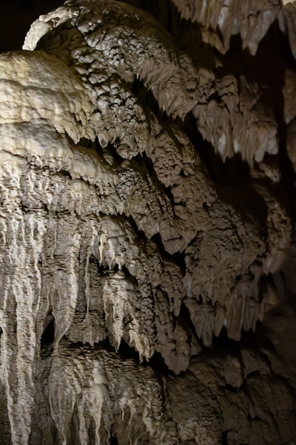 The cave is karst amazing view of stalactites and stalagnites illuminated by bright light