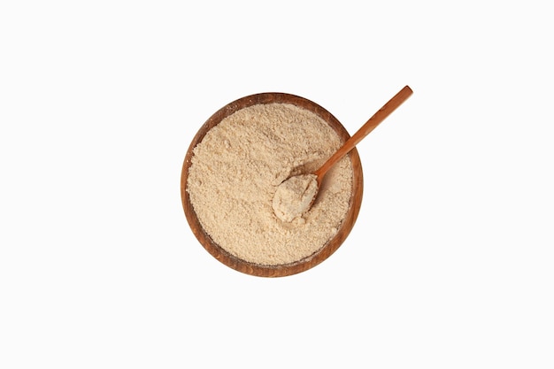 Cedar flour in wooden bowl with spoon Natural ground pine nuts Cedar flour is used in culinary