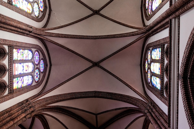 Ceiling of a Catholic church with stained glass windows in Poland