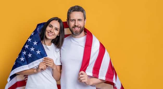 Photo celebrating the american spirit couple draped in the flag advertisement american family couple with flag a couple proudly posing with the american flag patriotism of couple with the american flag