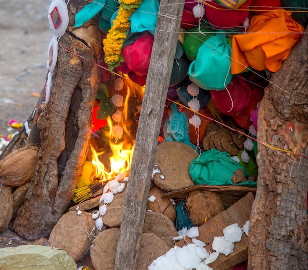 Celebrating Holika Dahan by worshiping and setting fire of wood logs or coconut also known as the festival of colors Holi or the festival of sharing